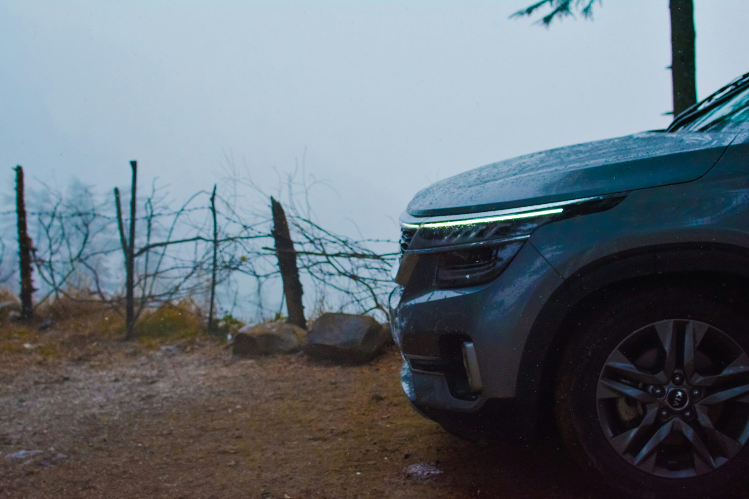 a car parked on the side of a dirt road