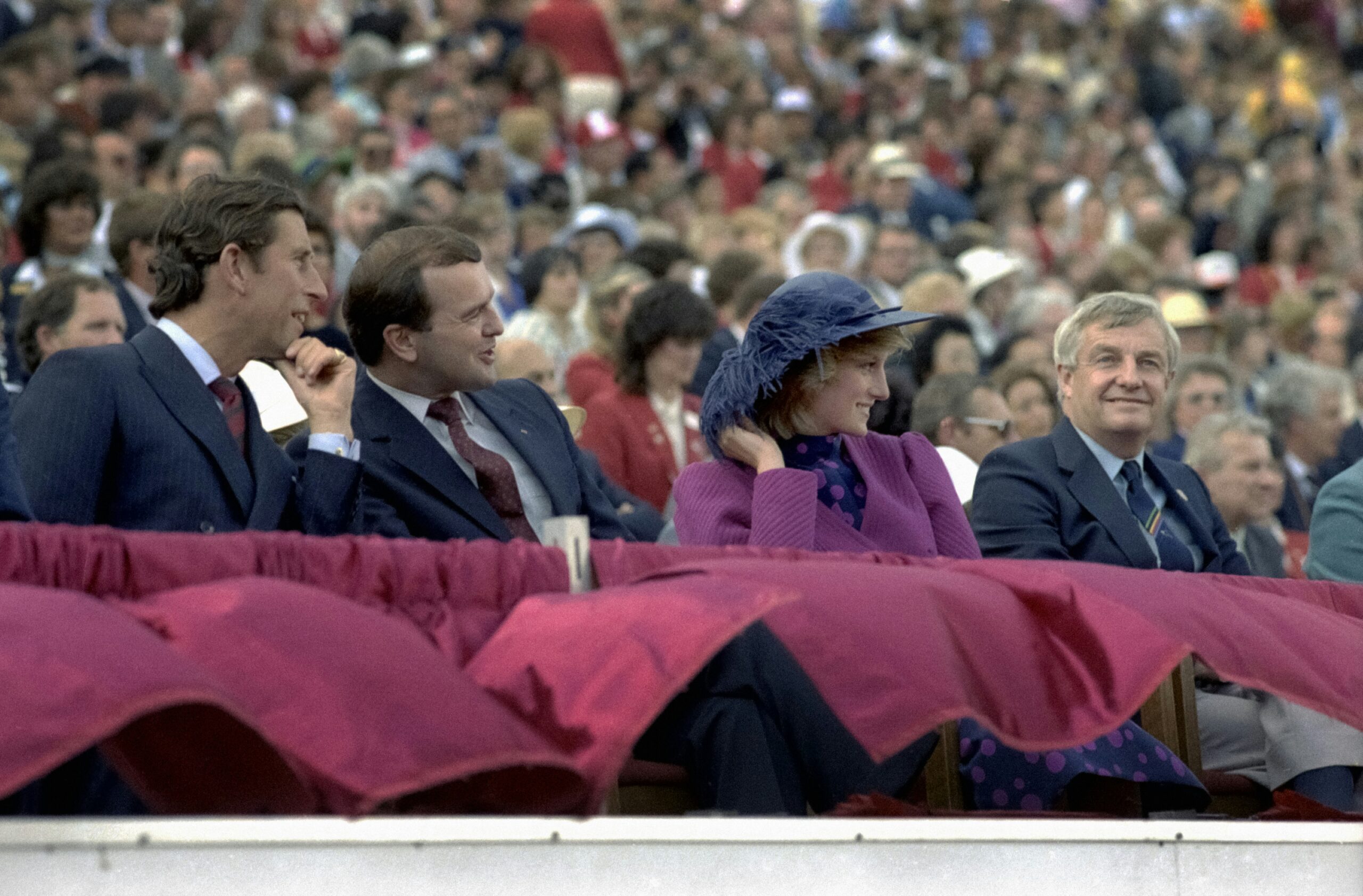 a group of people sitting next to each other in front of a crowd