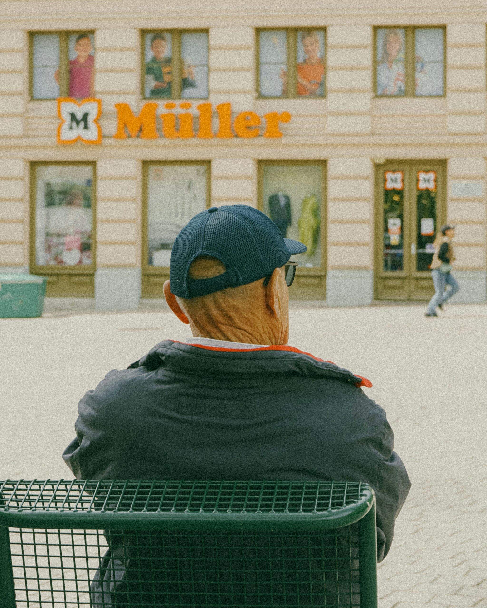 a man sitting on a bench in front of a building