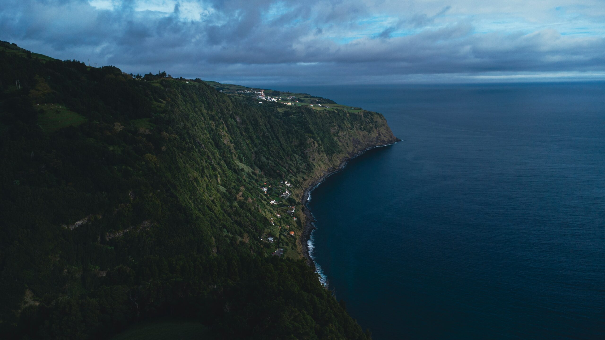 an aerial view of a cliff overlooking the ocean