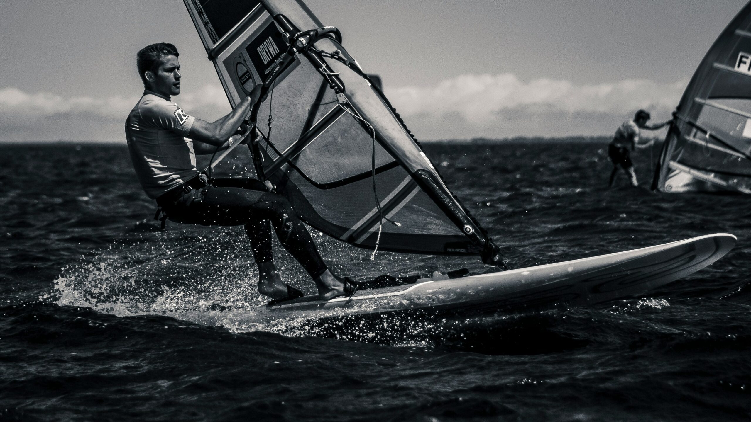 man riding surfboard with sail