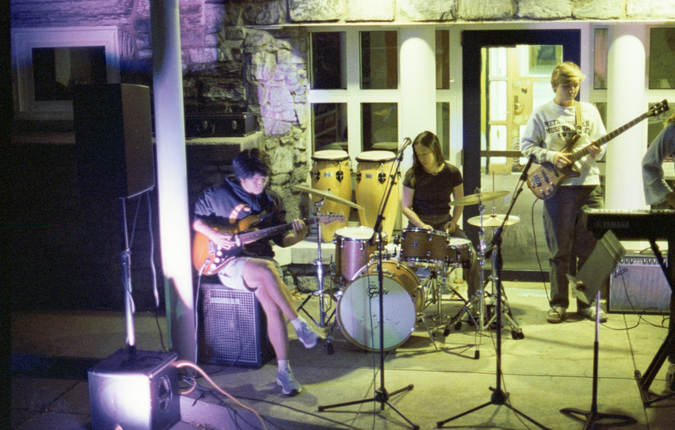 A group of people playing instruments in a room