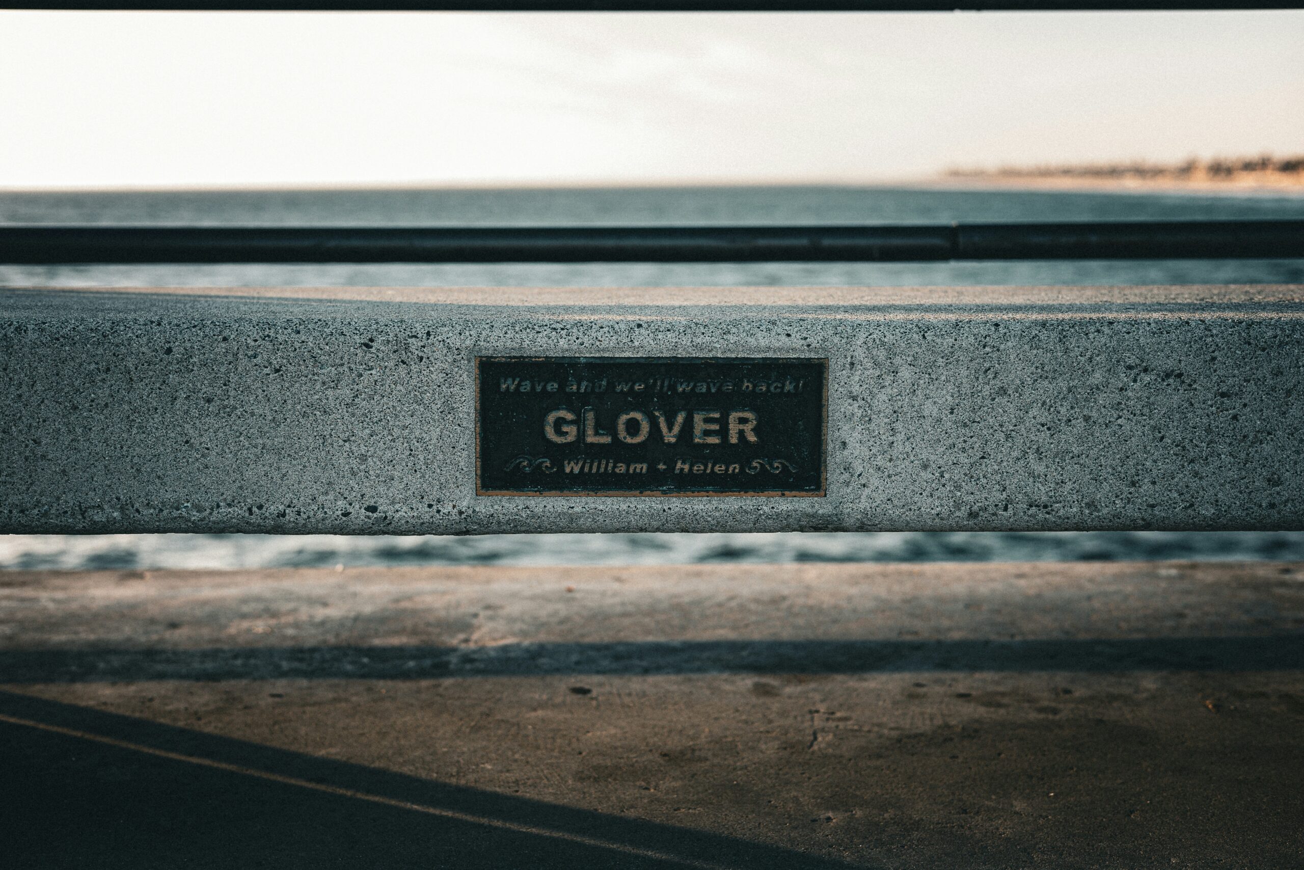 a close up of a bench with a sign on it