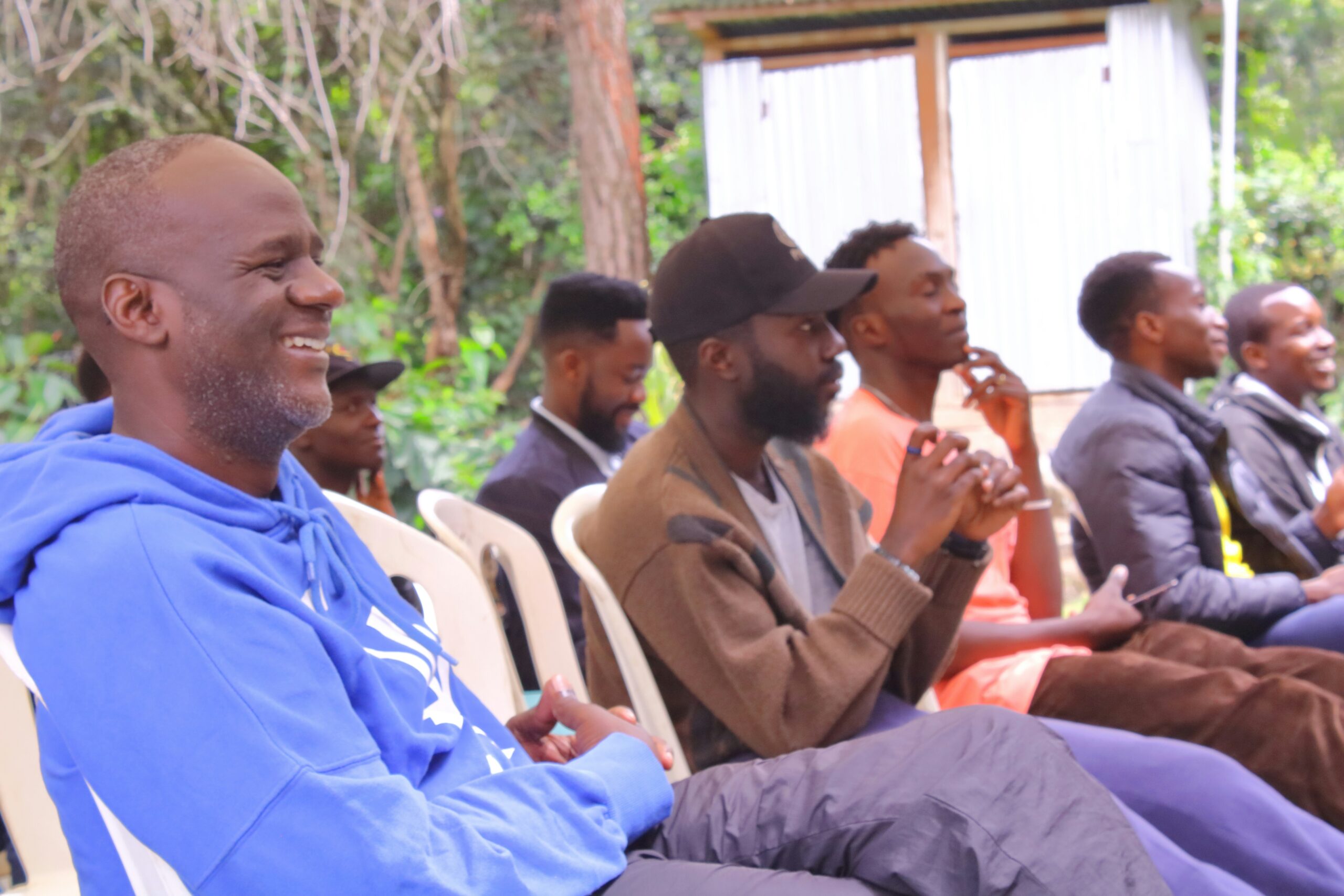 a group of men sitting outside