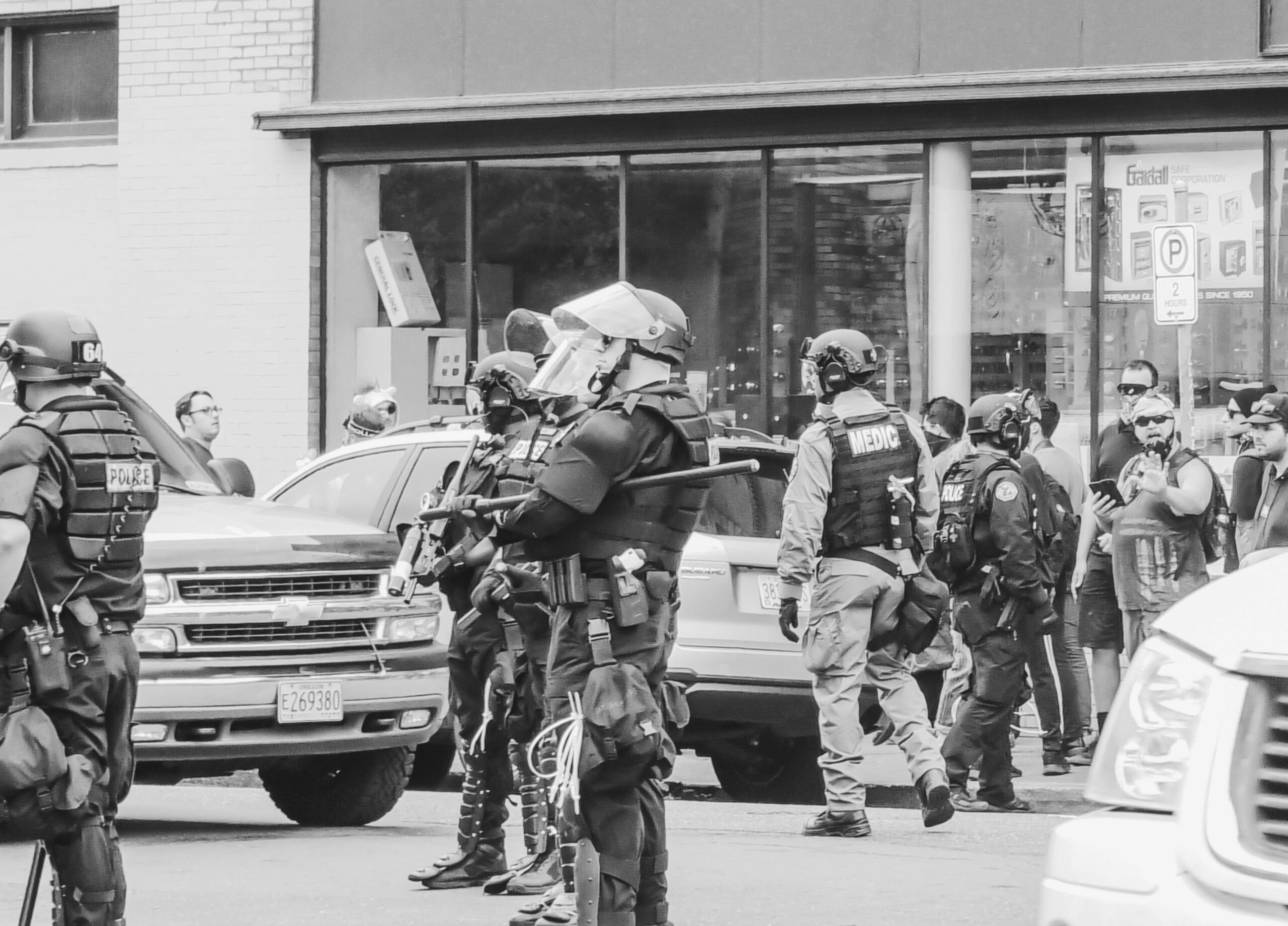 grayscale photo of policemen wearing gears