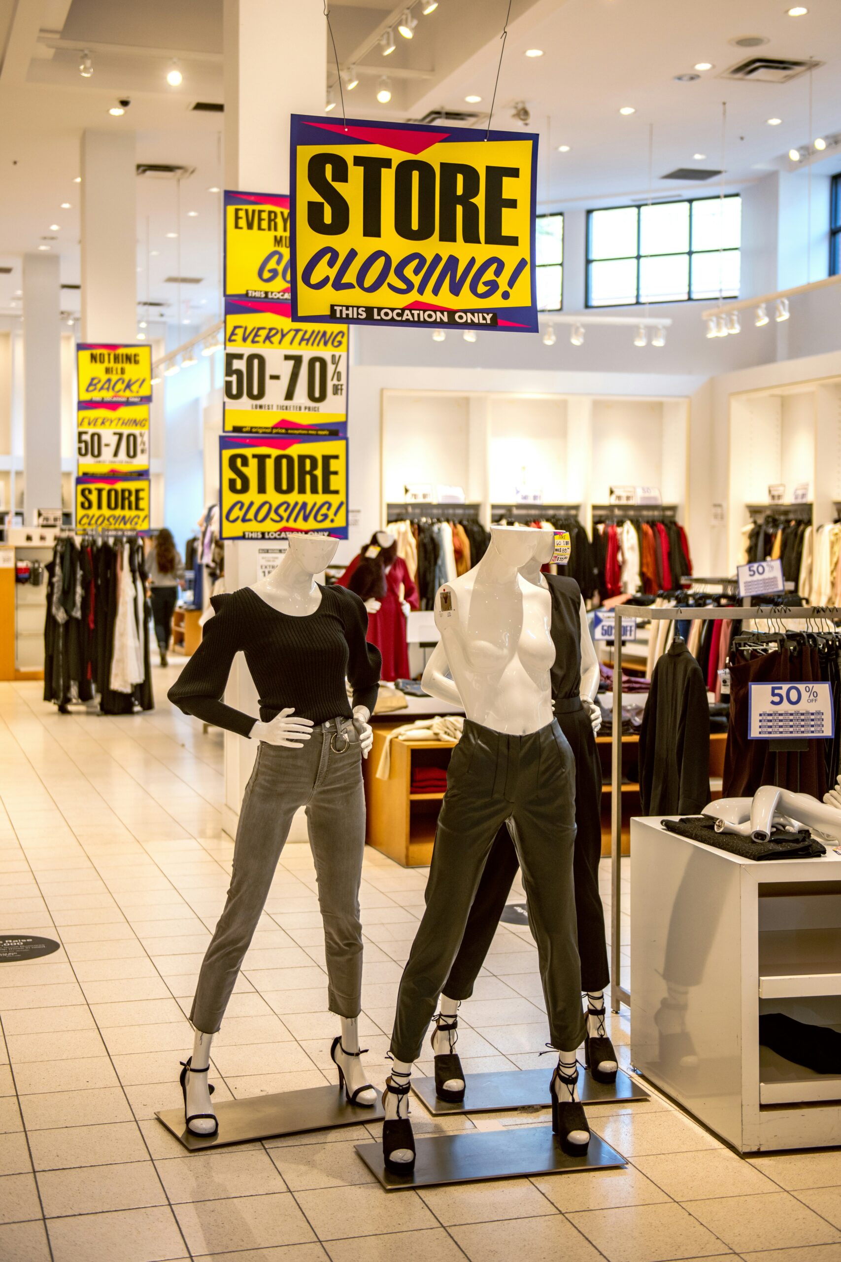 man in black long sleeve shirt and white pants standing beside woman in white long sleeve