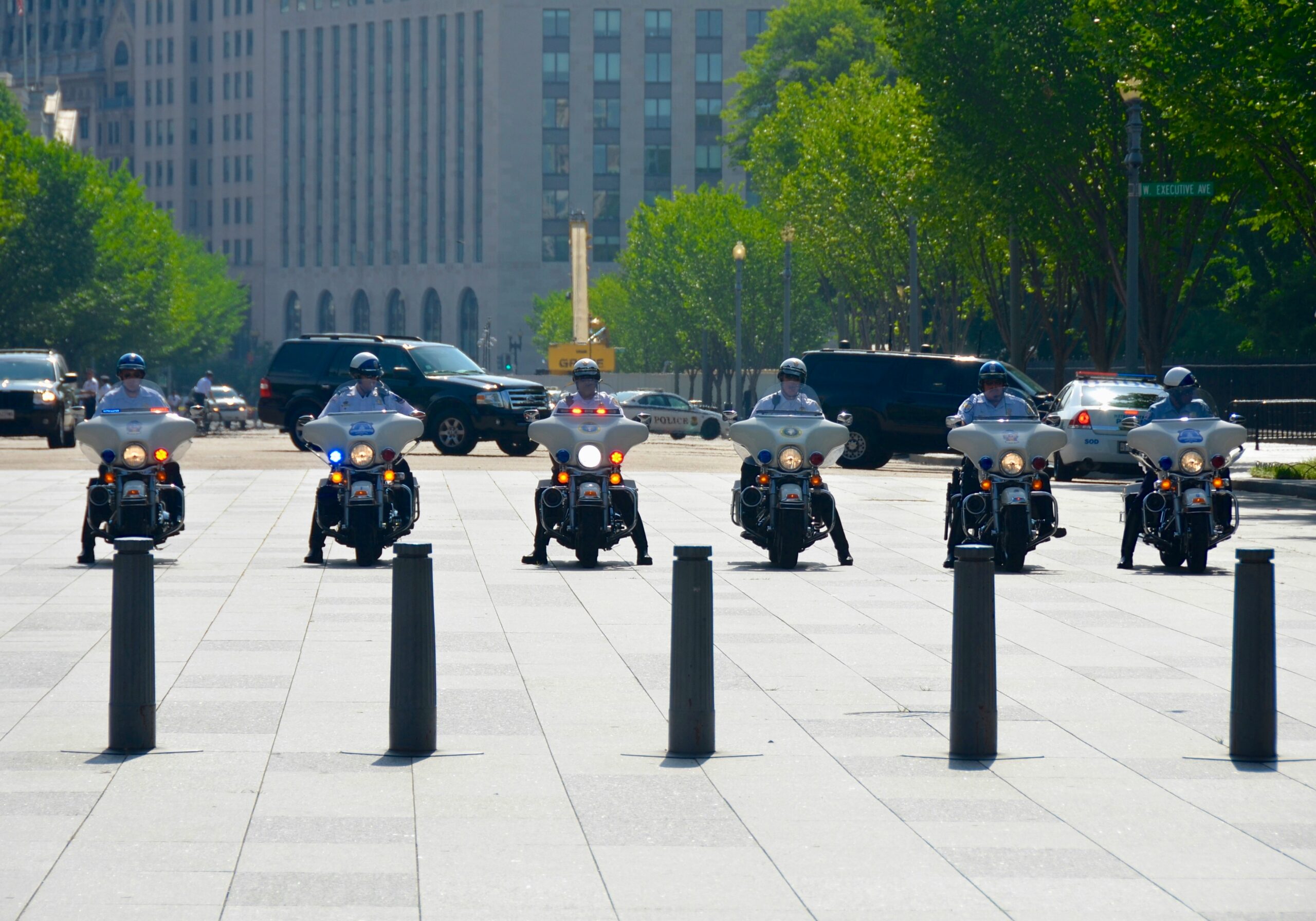 six men riding motorcycles