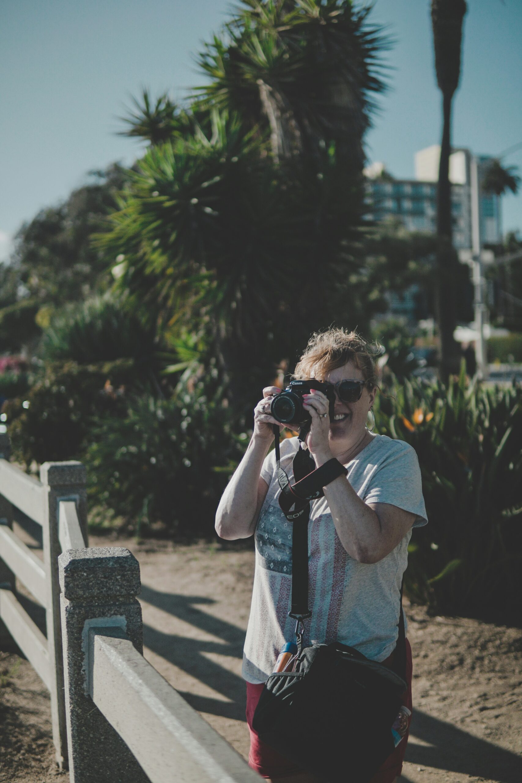 woman holding black camera during daytime