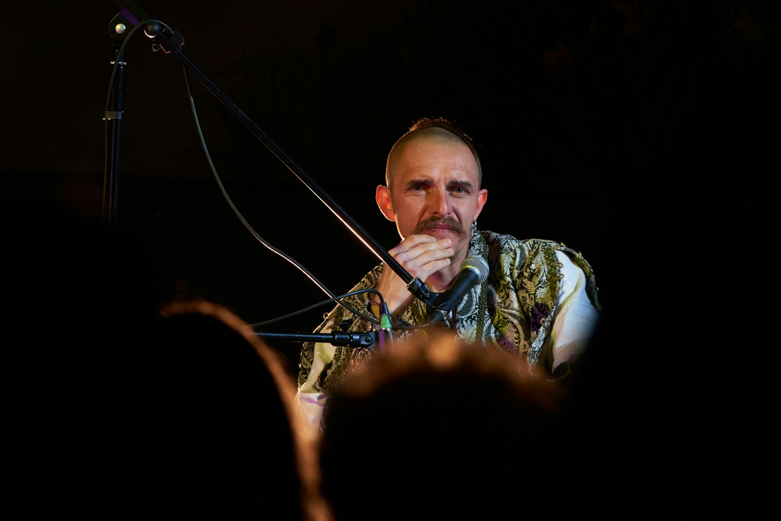 a man standing in front of a microphone