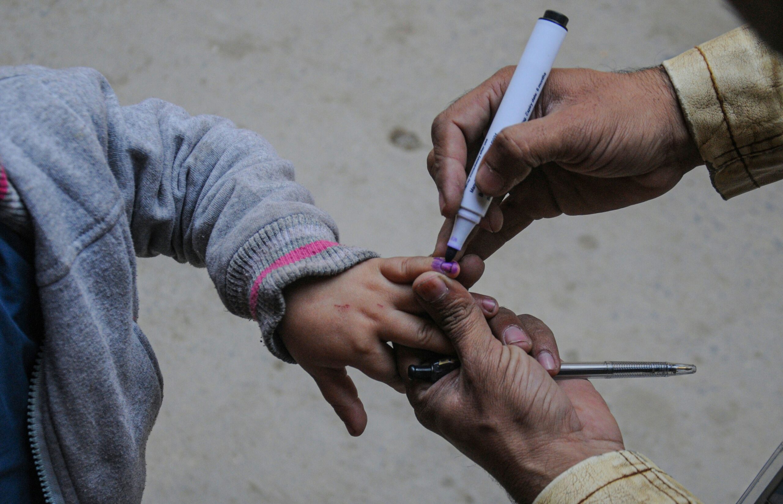 a person holding a cigarette and a child's hand