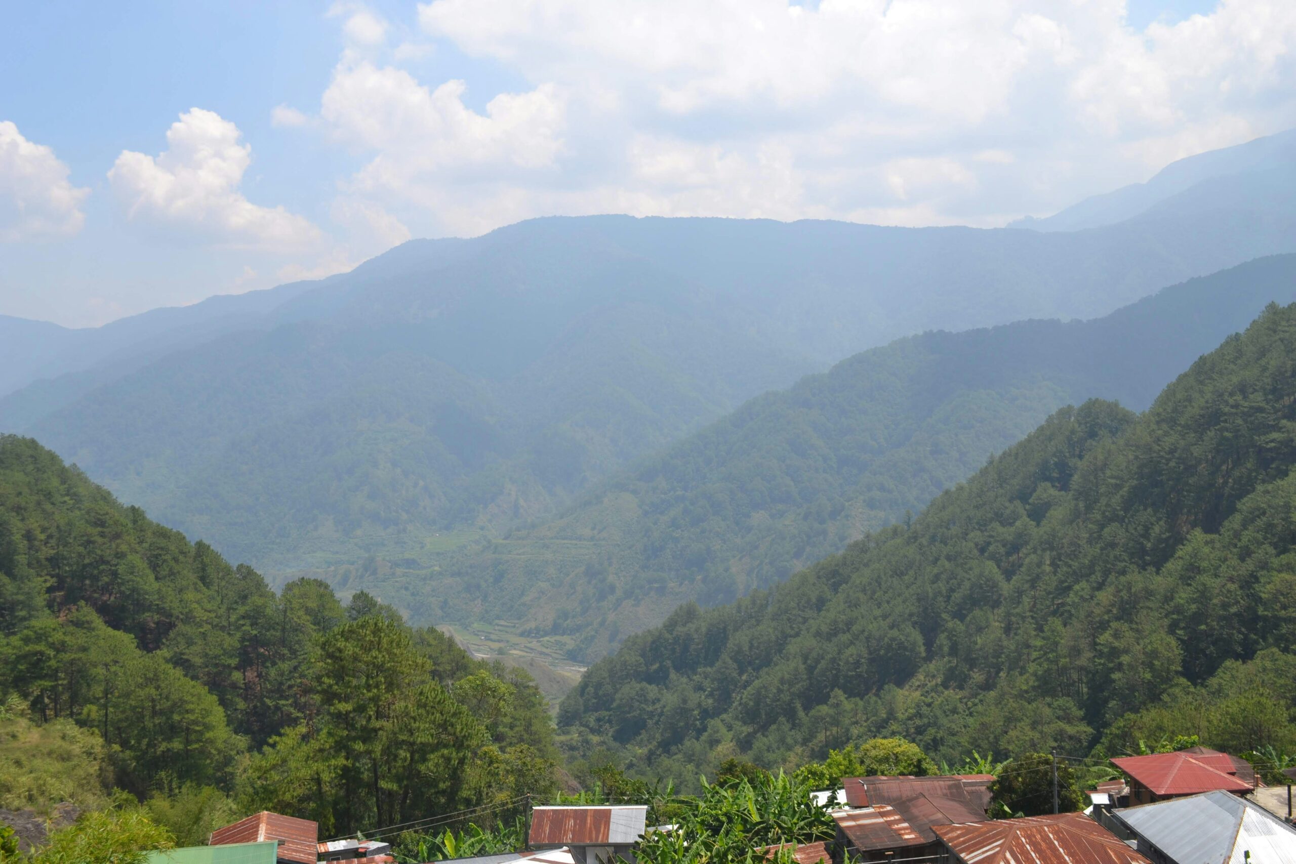 a view of a mountain range with houses in the foreground