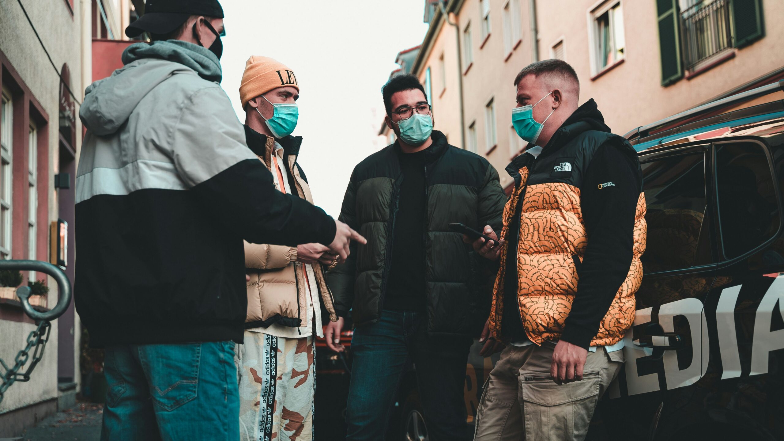 man in black jacket standing beside man in black jacket