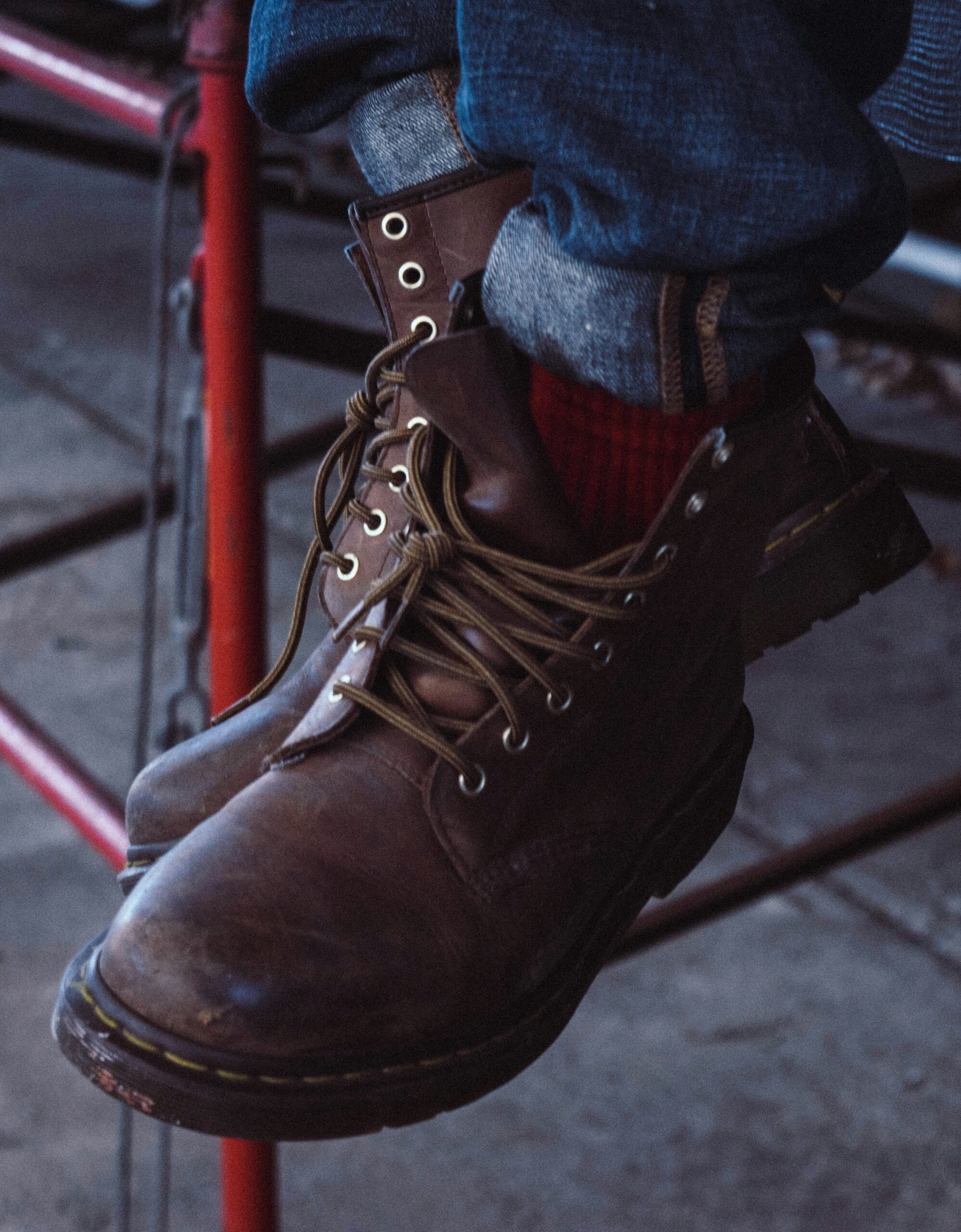 person wearing brown leather boots