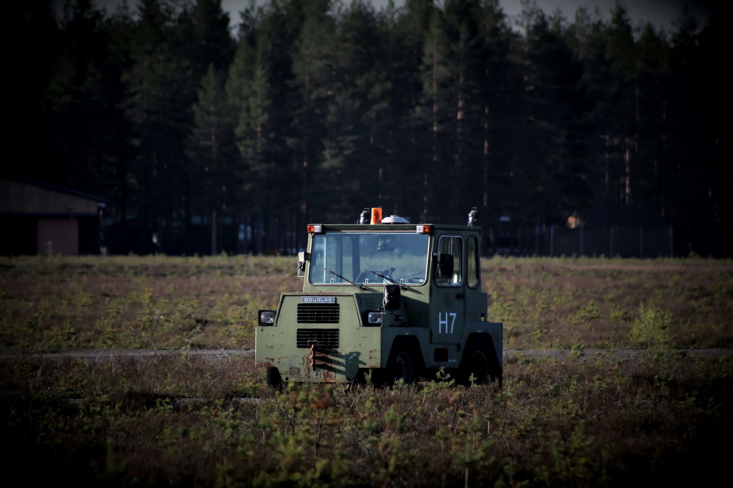 white and blue truck on green grass field during daytime